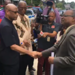 Ancel Roget of OWTU delivers the letter to a government representative