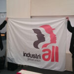 Brian Kohler with Peter Knowlton, President of IndustriALL US affiliate, UE, holding the IndustriALL banner at the trade union space.
