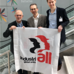 IndustriALL base metals director Adam Lee centre.